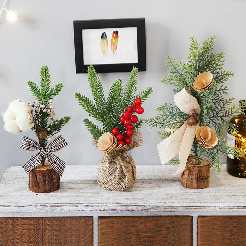 Decorative floral arrangements on wooden logs with a framed picture in the background.