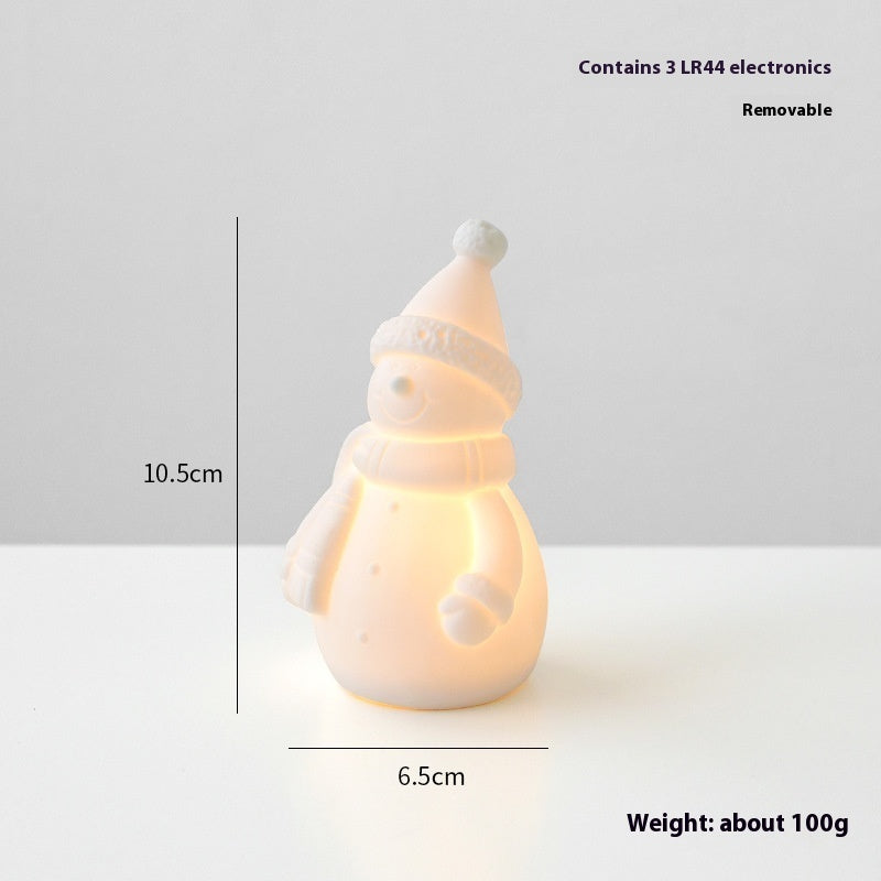 Snowman-shaped night light with measurements and weight information on a white background