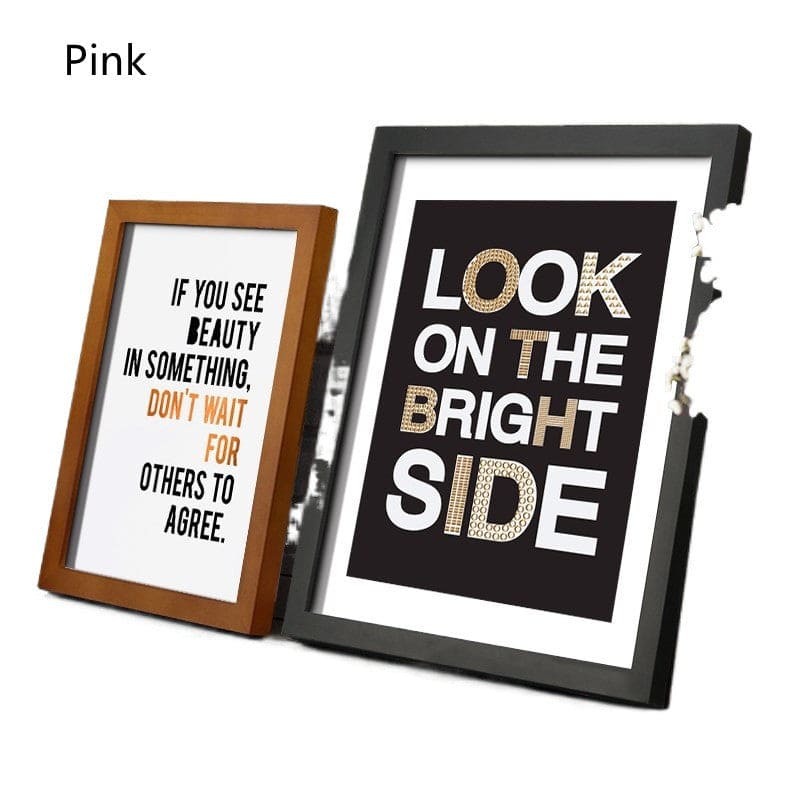 Two framed prints with motivational quotes in different frames on a white background.