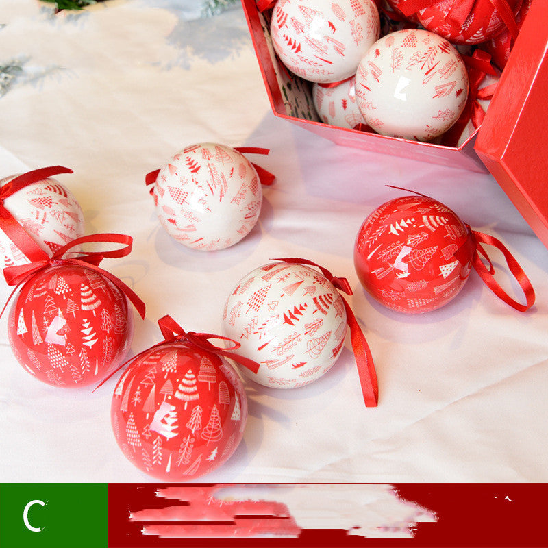 Decorative Christmas balls with red and white patterns on a white surface.
