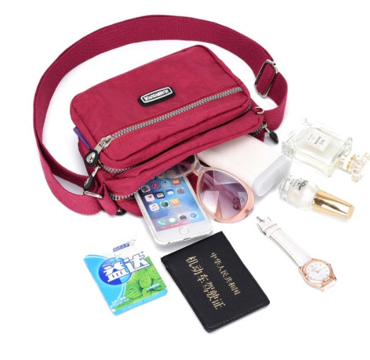 Women's Compact Multi Compartment Messenger Bag showing internal capacity | Confetti Living