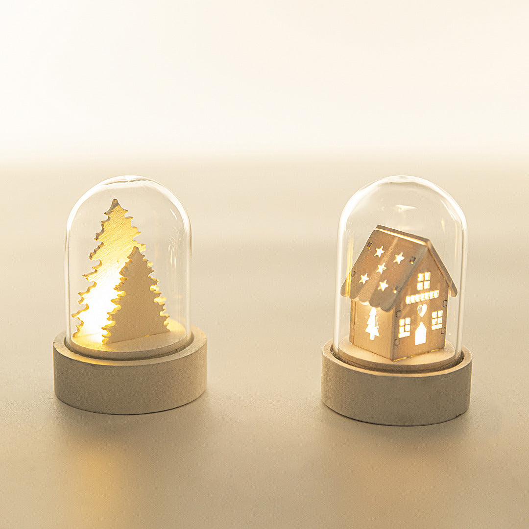 Two decorative night lights shaped like a tree and a house, each inside a glass dome on a beige background.