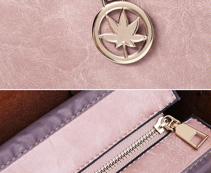 Pink wallet with gold zipper and leaf-shaped keychain on a matching pink background