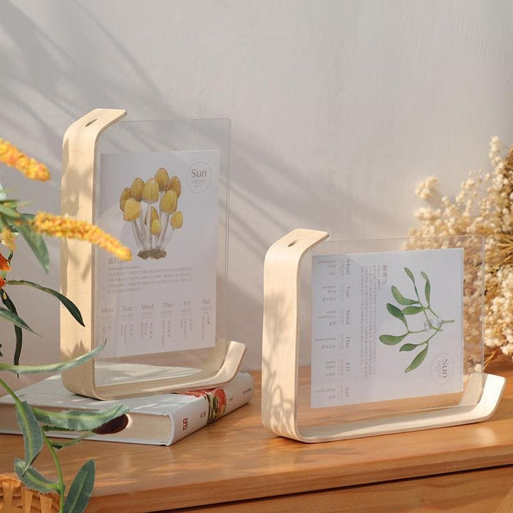 Two wooden bookends with plant-themed designs on a wooden surface.