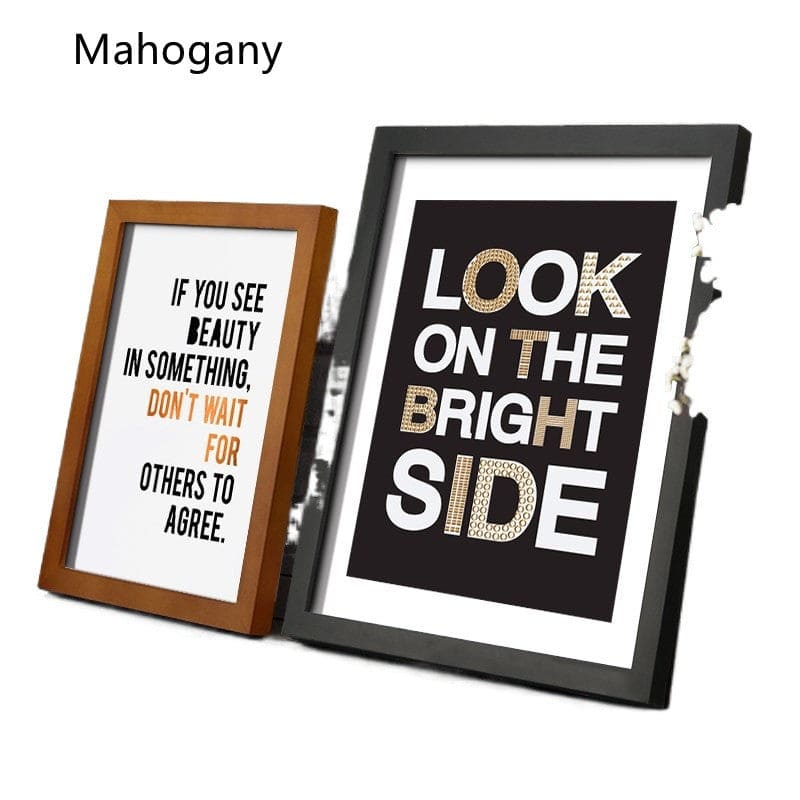Two framed prints with motivational quotes in different frames on a white background.