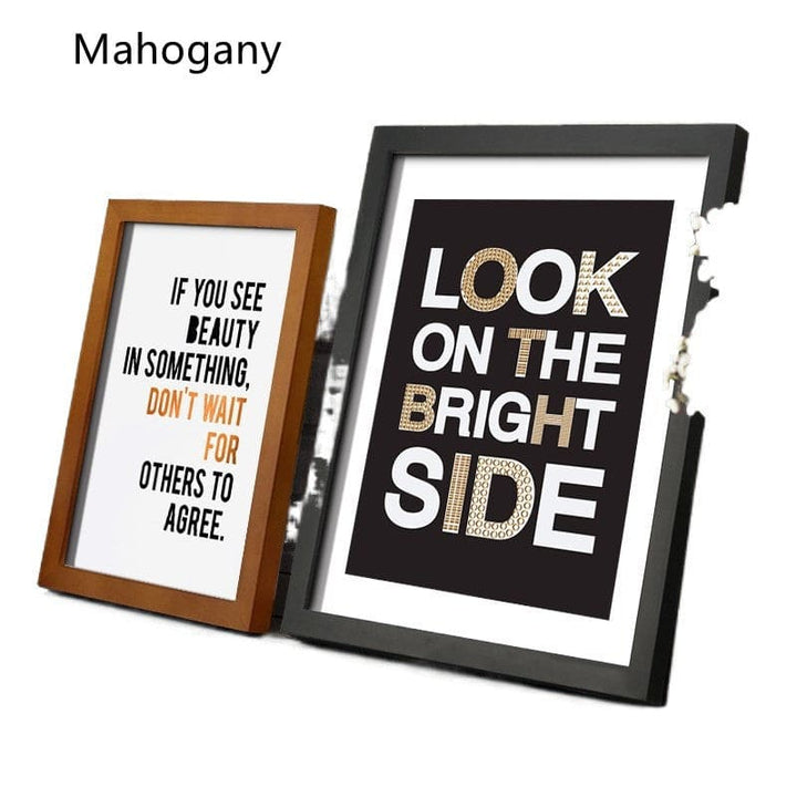 Two framed prints with motivational quotes in different frames on a white background.