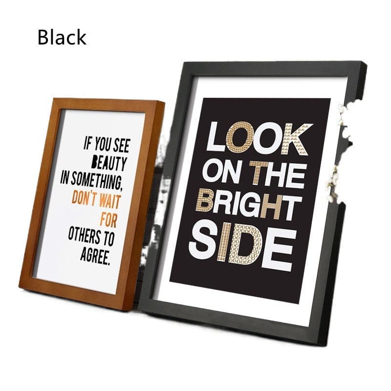 Two framed prints with motivational quotes in different frames on a white background.