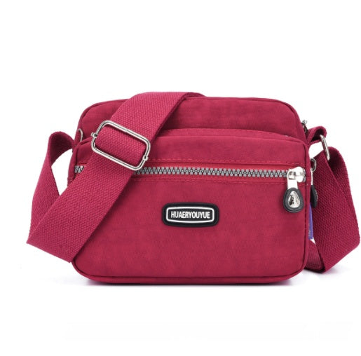 Women's Compact Multi Compartment Messenger Bag showing Magenta | Confetti Living