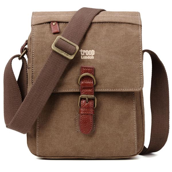 Classic brown shoulder bag from Troop London is made of super strong canvas with genuine Italian leather trim and detailed zip pullers. Lined in PU backed cotton. Front facing orientation showing shoulder strap.