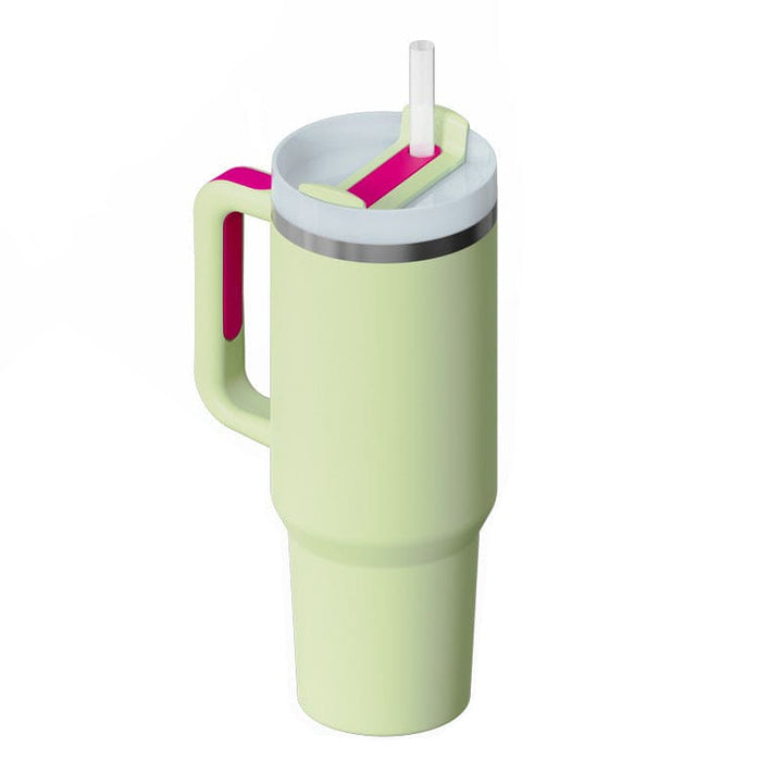 Light green tumbler with a pink handle and straw on a white background