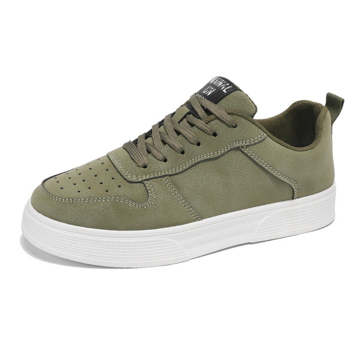 Green sneaker with white sole on a white background