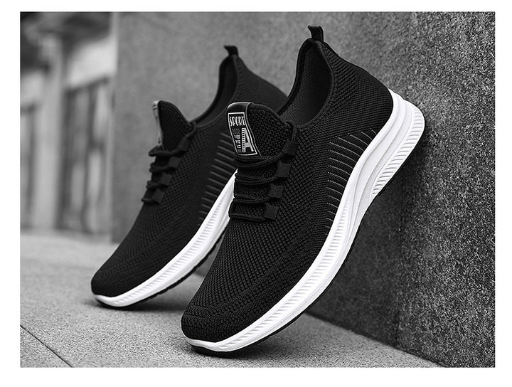 Black fashion sneakers with white soles leaning against a wall | Confetti Living