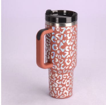 Travel mug with leopard print pattern on a light purple background