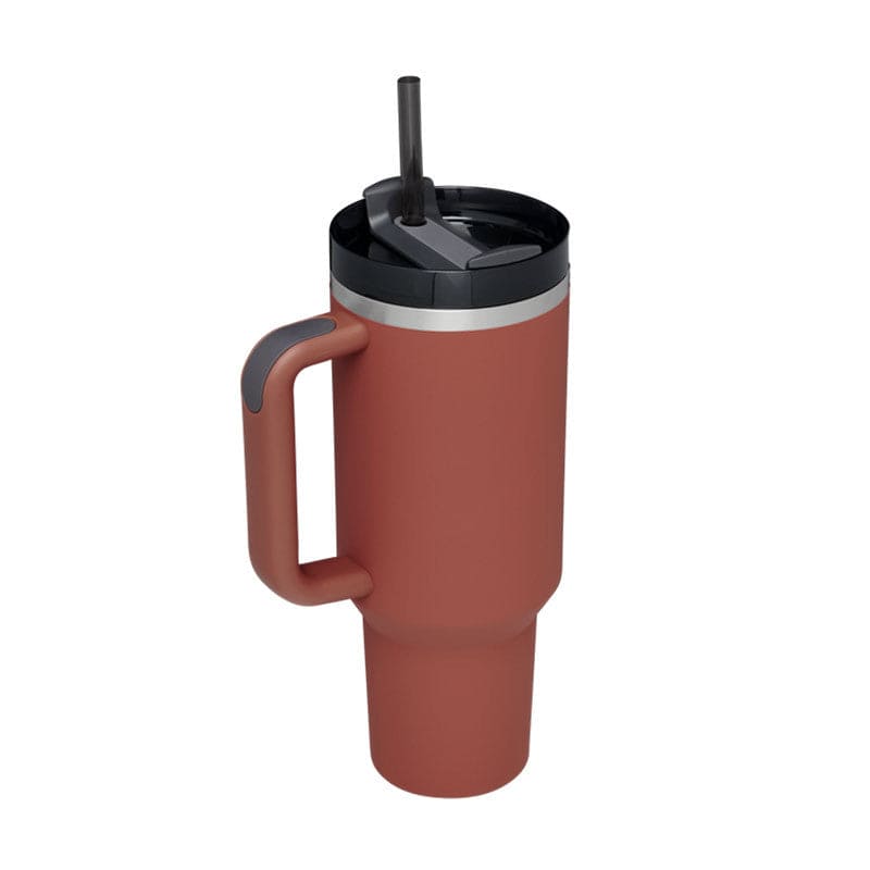 Red travel mug with a black lid and straw on a white background