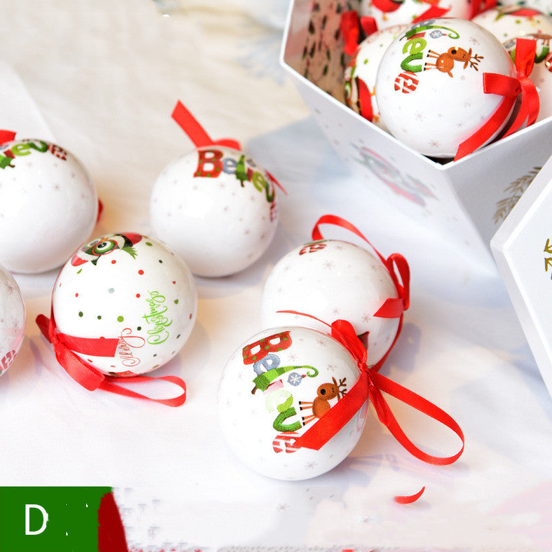 Decorative Christmas balls with red ribbons on a white surface