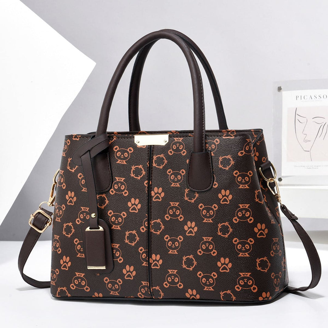 Brown handbag with panda pattern on a white background