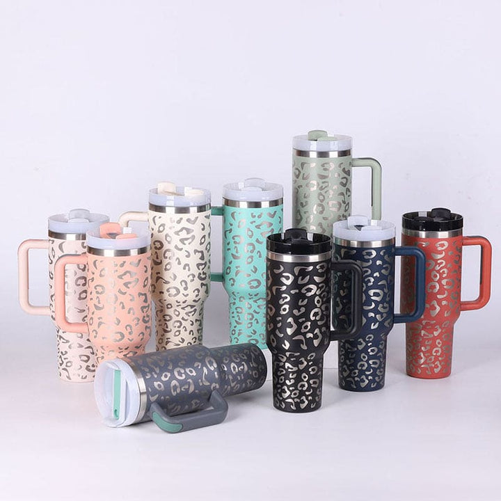 Collection of insulated travel mugs with leopard print pattern on a white background