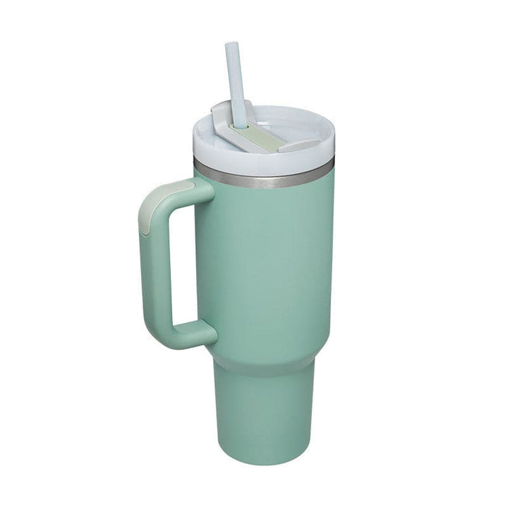 Mint green tumbler with handle and straw lid on a white background