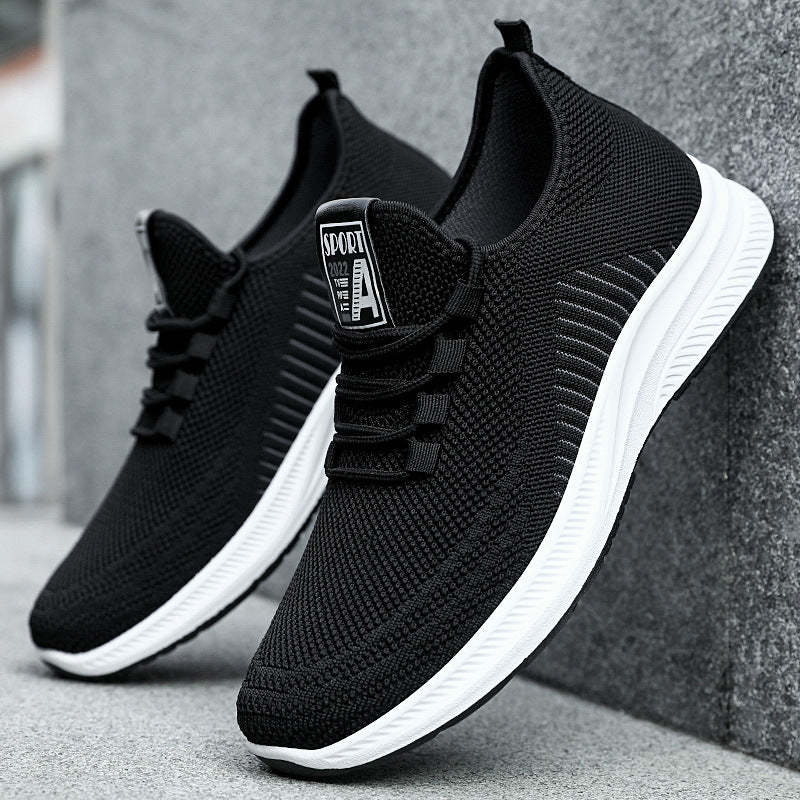 Black fashion sneakers with white soles on a grey backround | Confetti Living