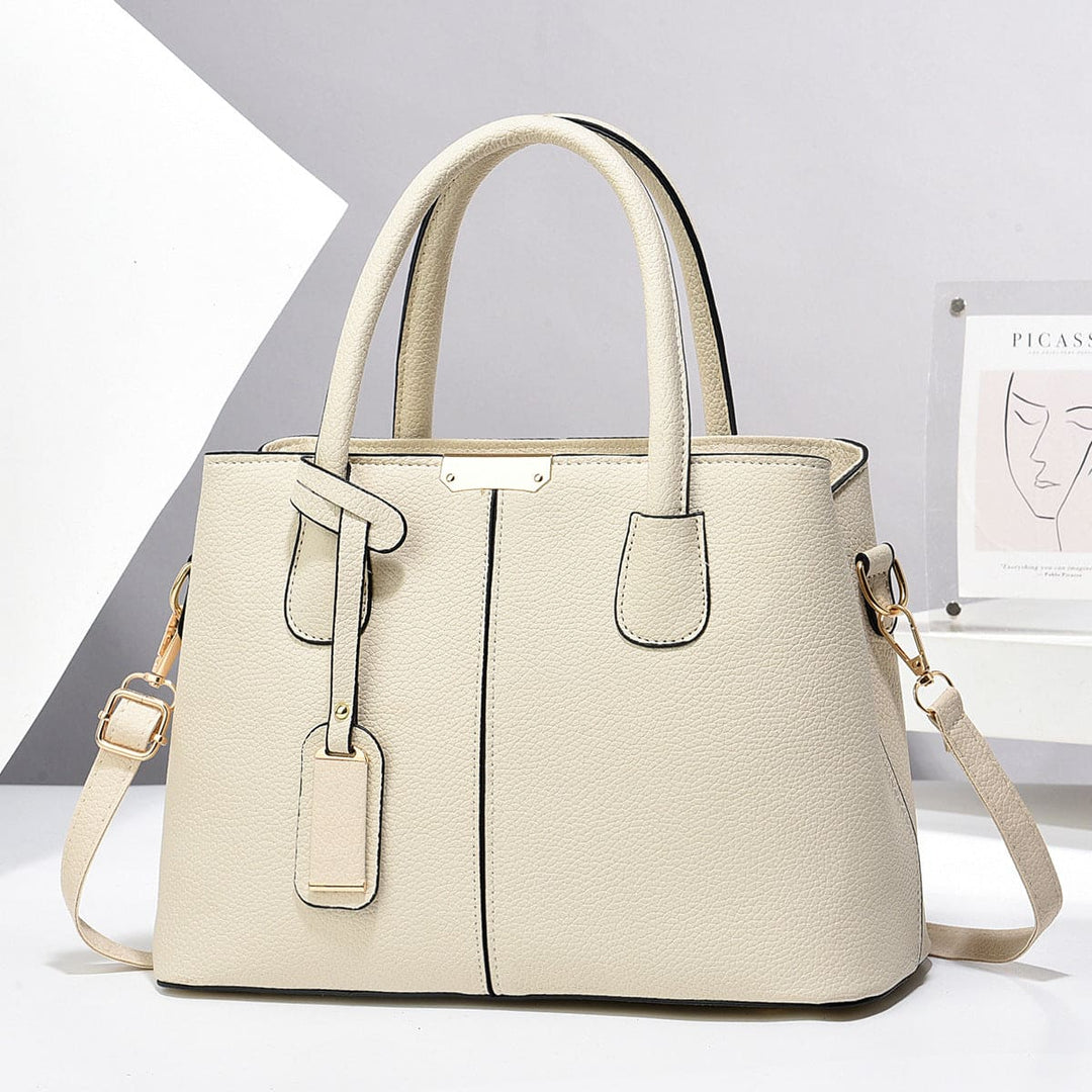 Beige handbag with a strap on a white background