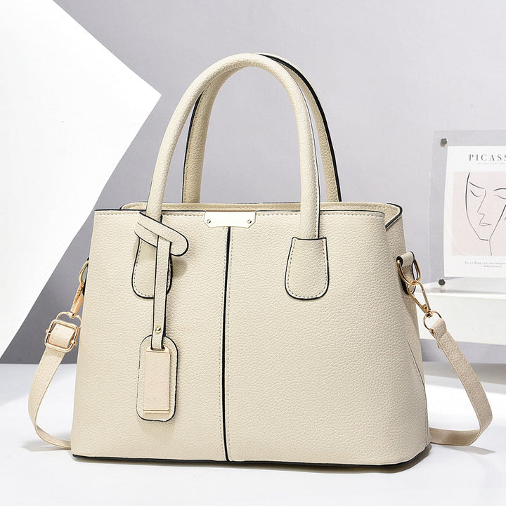 Beige handbag with a strap on a white background