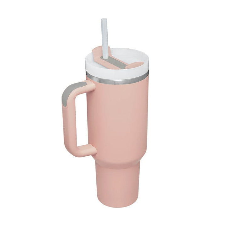 Pink tumbler with a handle and straw lid on a white background