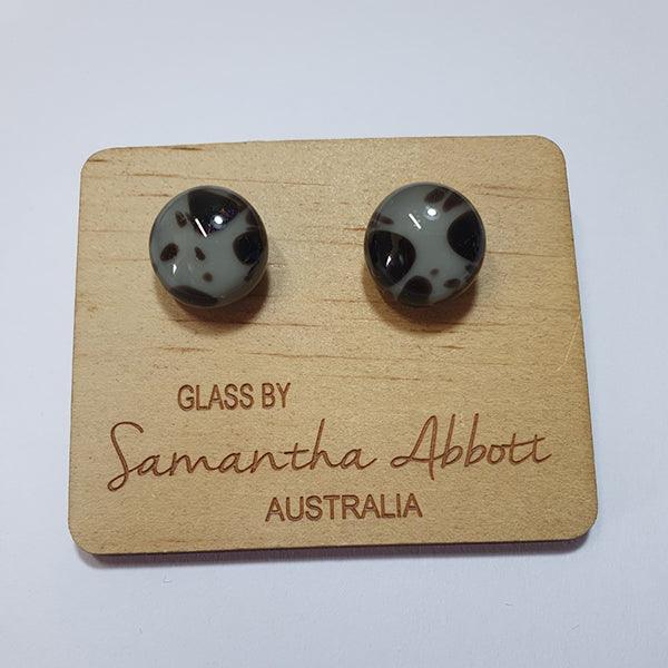 #7 Black multi glass stud earrings shown on a natural plywood holder. 