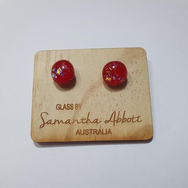 #7 Red glass stud earrings shown on a natural plywood holder. 