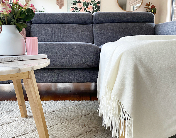 Chiswick Ivory Merino Throw Blanket showing product in lounge area | Confetti Living