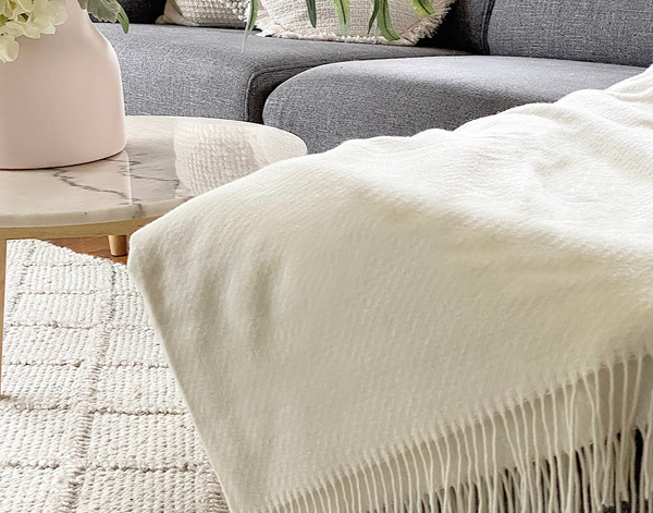 Chiswick Ivory Merino Throw Blanket showing product in use | Confetti Living