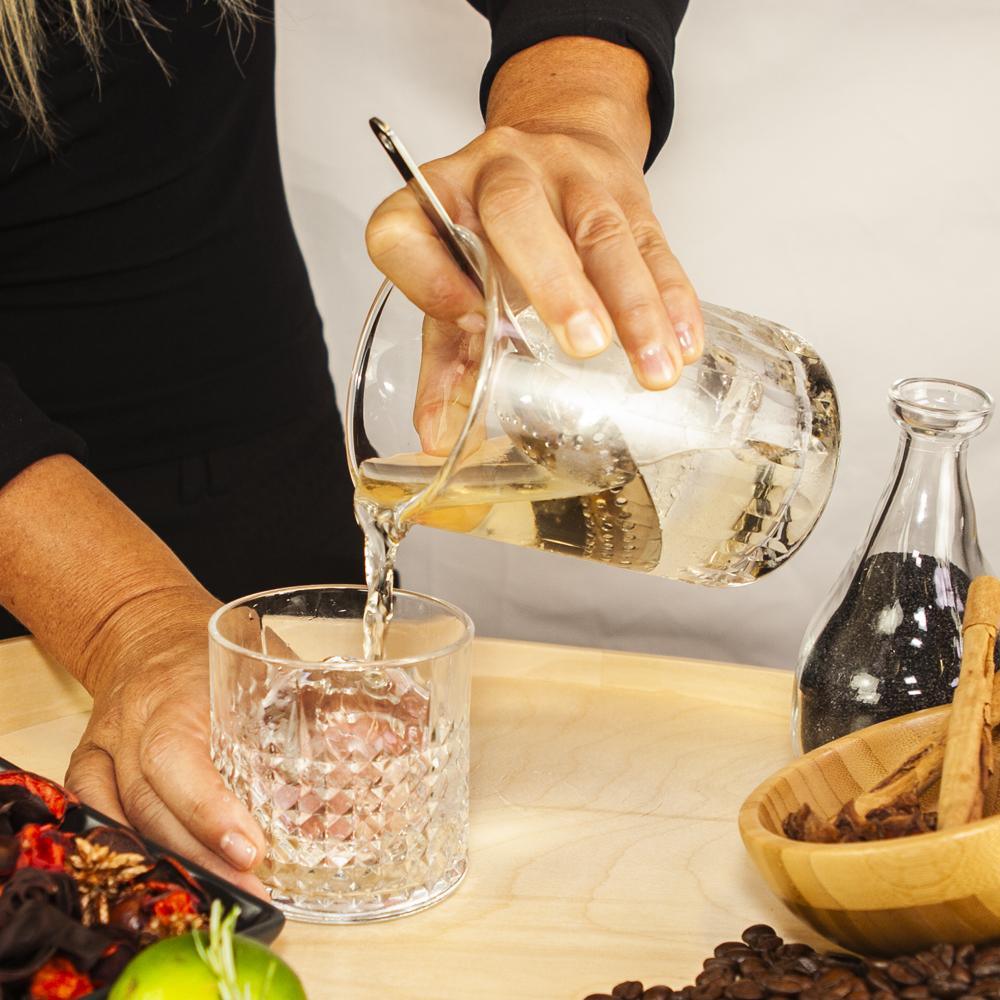 Lifestyle picture showing the Juliep™ strainer and ice scoop in use. Professional bar tools from Confetti Living.