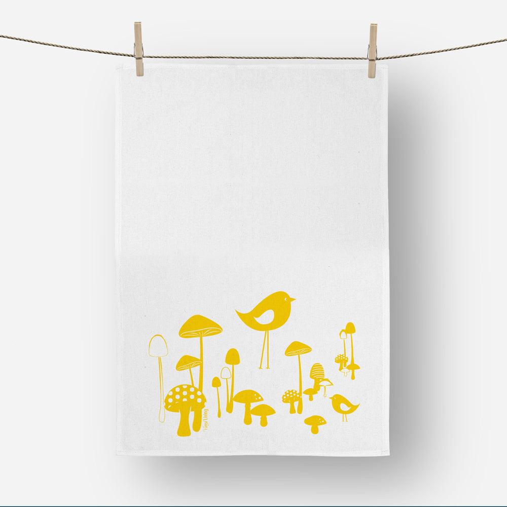 Mushrooms and birds printed linen tea towel in bright yellow print on a white background